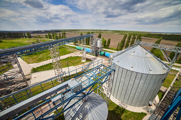 Metal elevator (grain silo) in agriculture zone. Grain Warehouse or depository is an important part of harvesting. Сorn, wheat and other crops are stored in it. Top view