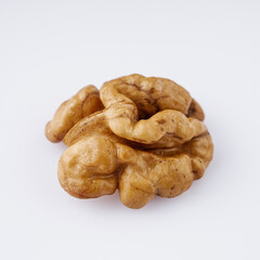 dried walnuts on a white acrylic background