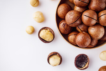 fresh macadamia nuts on a white acrylic background