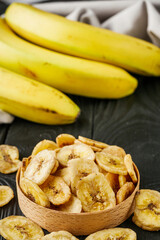 delicious dried banana on a black wooden rustic background