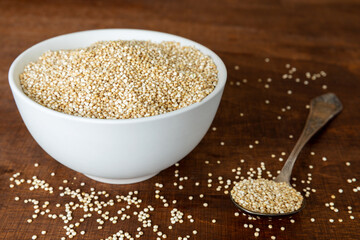 Quinoa grains in bowl on a table. Healthly gluten free grains.