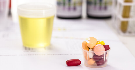oral pills for urinary tract infection problems, lab tests and bottles with urine collected in the...