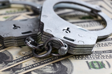 Cash in US Dollars, Real Handcuffs. The Concept of Arrest, Corruption, Bail, Crime, Bribery or...
