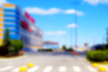 Background, blur, out of focus, bokeh. Office building with well-maintained parking blurred urban background.