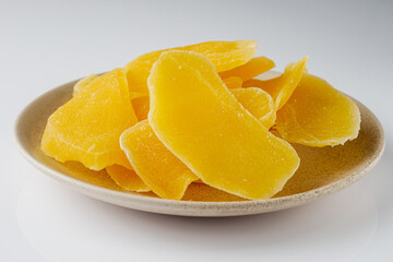 delicious dried mango on a white acrylic background