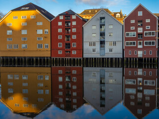 Historical wharf warehouses flanking both sides of the Nidelva river, in the Old Town of Trondheim, Trøndelag, Norway