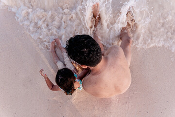 Father and daughter playing in the beach
