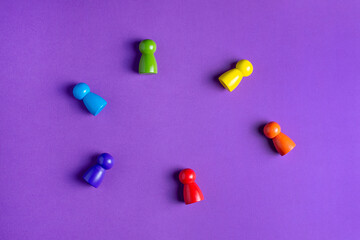 Colorful Waldorf wooden human figure rainbow in a montessori teaching pedagogy on purple background, kid play concept