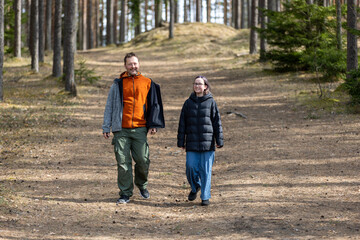 Fototapeta premium Young happy family father and daughter during a walk in the spring park. Portrait dad with child together. Family holiday in garden or forest