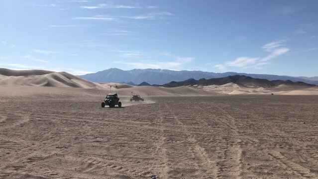 Dumont Dunes. Group of people drive on buggies at the dunes in California. High quality 4k footage