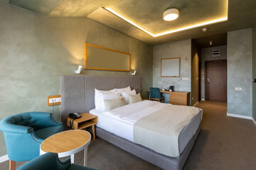 Interior of a luxury hotel double bed bedroom in the morning