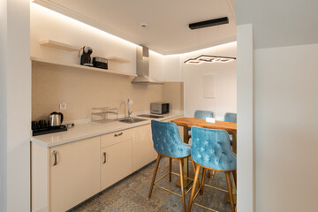 Interior of a modern new kitchen with dining table and chairs in the morning