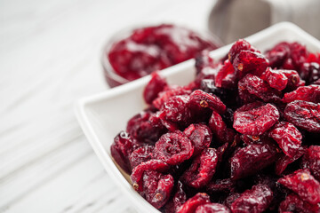 dried cranberry berry on a white wooden rustic background