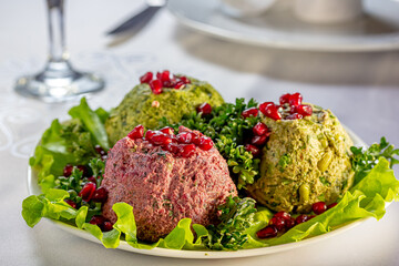 Pkhali or Phali is a Georgian snack made of beets, nuts and beans, herbs, garlic with pomegranate seeds