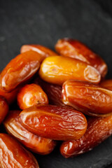 juicy royal dates on a black wooden rustic background