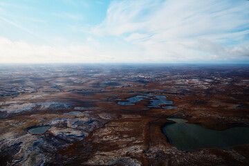 Aerial view and top view of the river in the tundra on the Taimyr Peninsula in Russia. Beautiful natural background. Blurred image, selective focus