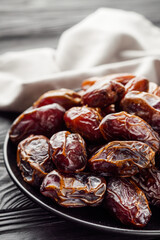juicy royal dates on a black wooden rustic background