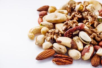 set of different nuts on a white acrylic background