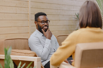a male psychologist conducts a patient's appointment in an office or a medical center. African...