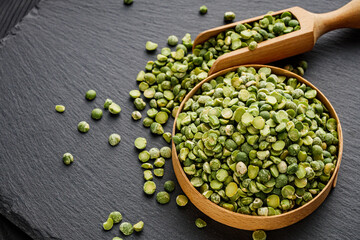 dried green peas on a black stone background