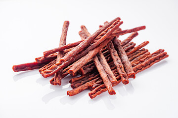 dried fish beer snack on a white acrylic background