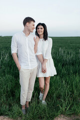  Young romantic couple in green field in spring