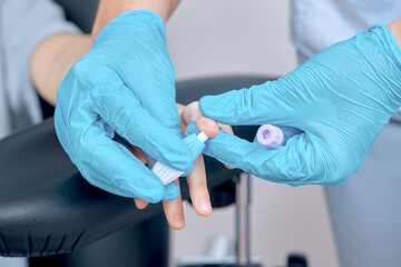 Obraz premium the process of taking blood from a finger for analysis