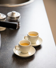 two cups of black coffee on the kitchen table