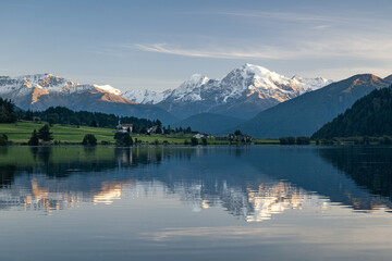 Fototapeta The snow-capped peak of the Ortler is reflected in the idyllic Haidersee, South Tyrol, Italy, Europe obraz