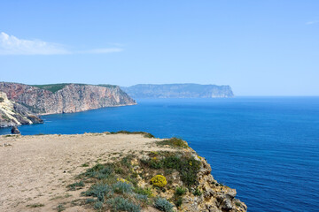 Fototapeta na wymiar Azure water, wild beach, beautiful rocks and bay near Grape cape. Cape Fiolent, Sevastopol, Crimea