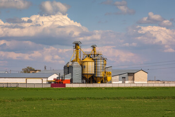 panorama view on agro silos granary elevator on agro-processing manufacturing plant for processing drying cleaning and storage of agricultural products, flour, cereals and grain.