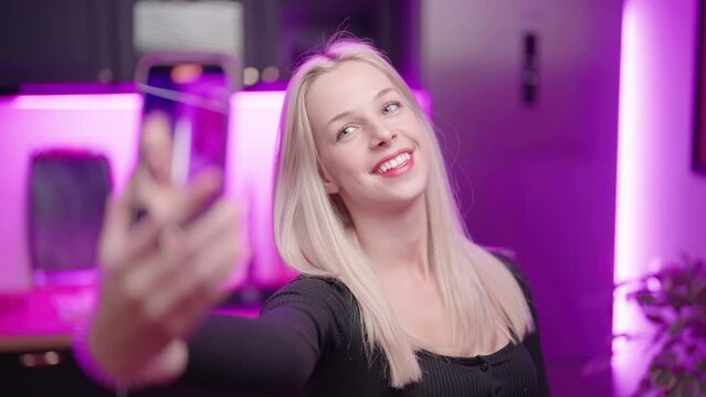 Cute blonde Influencer girl in kitchen pose for tik tok loopable video selfie 4K