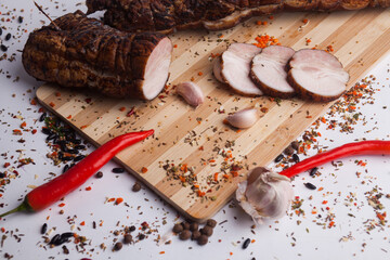 chopped roast pork on a wooden board, with rosemary and tomatoes, isolate