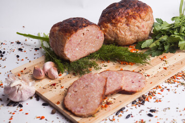 chopped roast pork on a wooden board, with rosemary and tomatoes, isolate