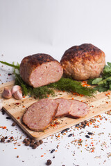 chopped roast pork on a wooden board, with rosemary and tomatoes, isolate