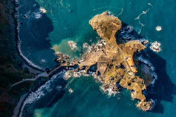 Aerial drone view of the island and the Gaztelugatxe temple. Northern Spain in winter. Manmade way to small isle on the Atlantic shore in Biscay region
