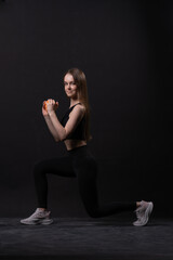 Fototapeta na wymiar On maiden beautiful orange . A with dumbbells background black orange two gym, from shape body in fit for female care, aerobics plus. Active beginner joy, figure young overweight doing