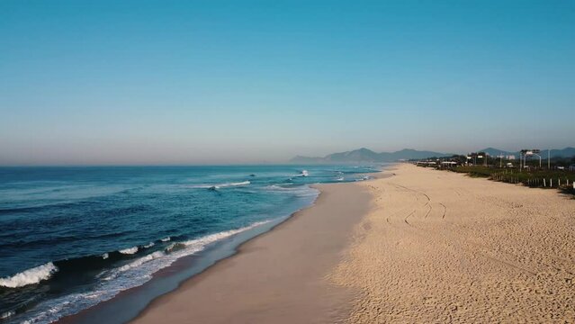Aerial view of Reserva beach, Marapendi lagoon and car traffic on Lucio Costa avenue. Barra da Tijuca and Recreio, in Rio de Janeiro, Brazil. Sunrise. Sunny day. Drone take. Praia da Reserva.