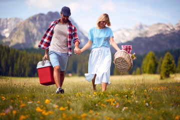 Smiling man and woman  enjoying picnic in nature.