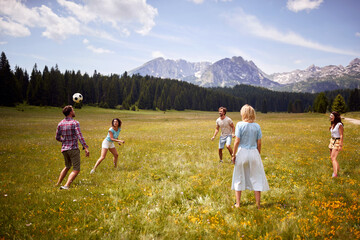 Group of friends playing with ball. sport outdoors of a group of people having fun playing soccer football