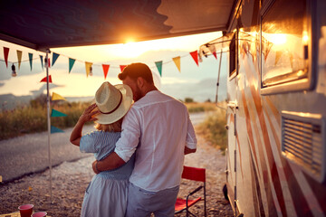 A young couple in love enjoying romantic moments at the campsite in the nature. Relationship, vacation, camping, nature