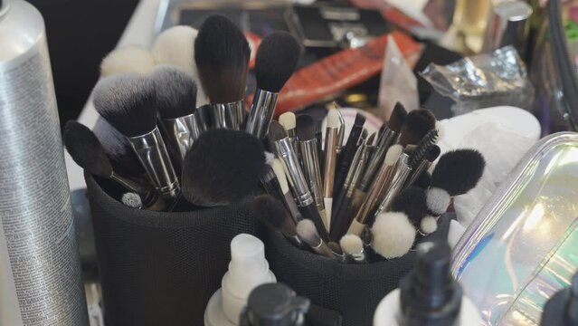 Cosmetic makeup brushes on vanity black furniture contemporary home small cups mirror interior design home decor