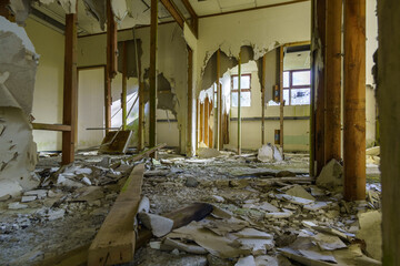 inside a damage abandoned building with destroyed wall and windows