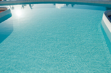 An inviting bright blue swimming pool with clear water ripple texture