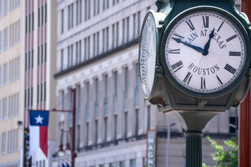 Roman Numerals Clock with Texas Flag in Background in Downtown Houston