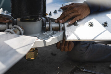 The mechanic is assembling the fan blades of the water tower system.