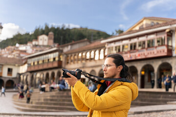 Tourist taking a picture in the main square of Cuzco.