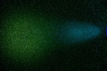 A beam of blue light on a dark green gradient background in fine grain