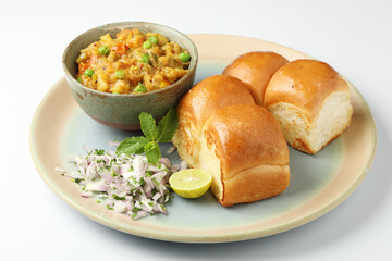 Mumbai Style Pav bhaji is a fast food dish from India, consists of a thick vegetable curry served with a soft bread roll, served in a plate