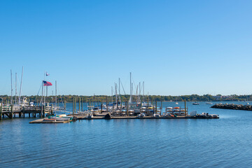 Fototapeta na wymiar Yachts docked at marina at Edgewood Yacht Club by Providence River in city of Cranston, Rhode Island RI, USA. 